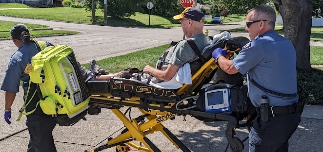 bob on stretcher with Larissa and Dave cropped